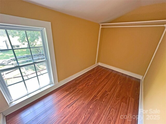2131 E NC-10 Hwy, Conover, NC 28613 - spare room with dark wood-type flooring, lofted ceiling, and baseboards