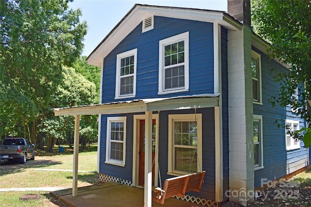 2131 E NC-10 Hwy, Conover, NC 28613 - view of front of home featuring a chimney, a front lawn, and a porch