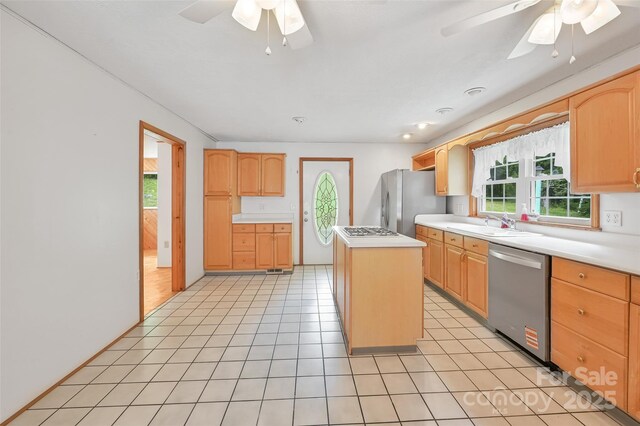 121 Walnut Holler Dr, Waynesville, NC 28786 - kitchen with stainless steel appliances, ceiling fan, light brown cabinets, and a center island
