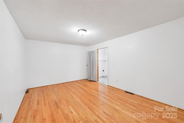 121 Walnut Holler Dr, Waynesville, NC 28786 - empty room with wood-type flooring and a textured ceiling