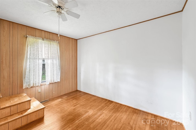 121 Walnut Holler Dr, Waynesville, NC 28786 - spare room with a ceiling fan, wood finished floors, ornamental molding, and wooden walls