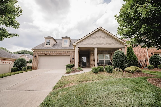 4518 Courtyard Blvd Unit 4, Harrisburg, NC 28075 - view of front facade with brick siding, a garage, concrete driveway, and a shingled roof