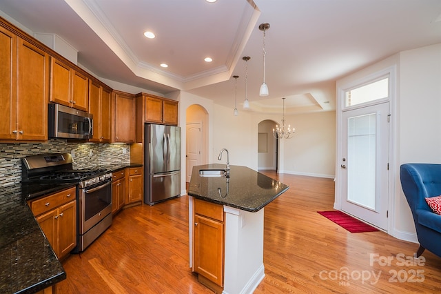 4518 Courtyard Blvd Unit 4, Harrisburg, NC 28075 - kitchen with a tray ceiling, stainless steel appliances, a chandelier, arched walkways, and ornamental molding