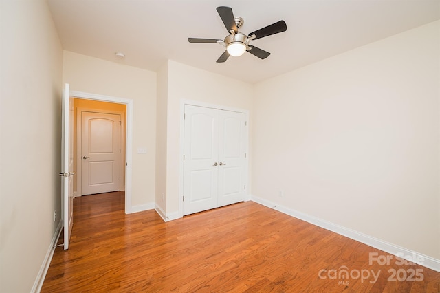 4518 Courtyard Blvd Unit 4, Harrisburg, NC 28075 - unfurnished bedroom featuring light wood-style floors, a closet, and a ceiling fan