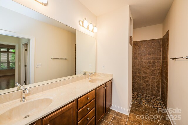 4518 Courtyard Blvd Unit 4, Harrisburg, NC 28075 - bathroom with double vanity, a tile shower, and tile patterned flooring