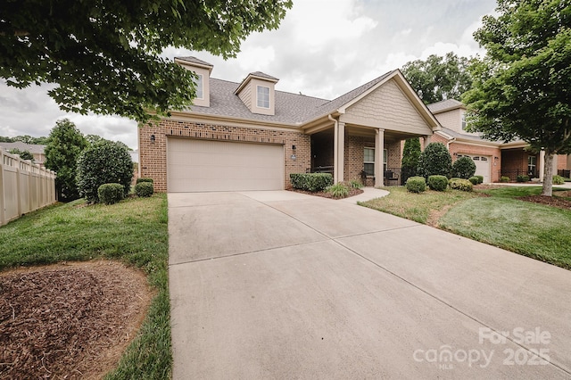 4518 Courtyard Blvd Unit 4, Harrisburg, NC 28075 - view of front of home with brick siding, a garage, driveway, a shingled roof, and a porch