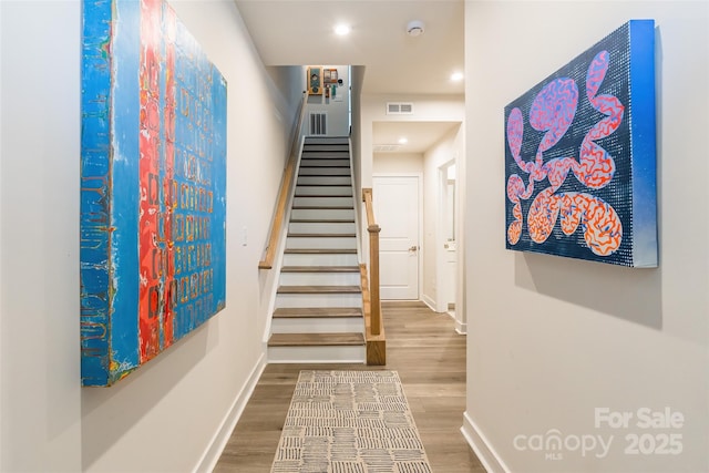 819 Anderson St, Charlotte, NC 28205 - stairway featuring wood finished floors, baseboards, and recessed lighting