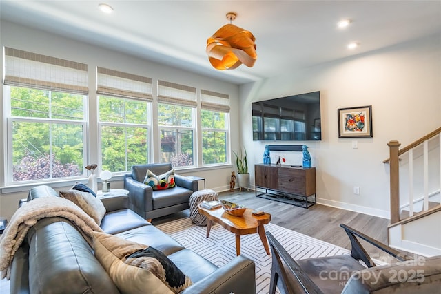 819 Anderson St, Charlotte, NC 28205 - living area with stairway, baseboards, wood finished floors, and recessed lighting