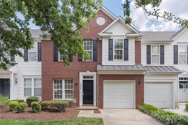 10225 Alexander Martin Ave, Charlotte, NC 28277 - view of property featuring brick siding, a garage, concrete driveway, a standing seam roof, and a metal roof