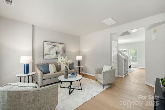 10225 Alexander Martin Ave, Charlotte, NC 28277 - living area featuring a chandelier and light wood-style floors