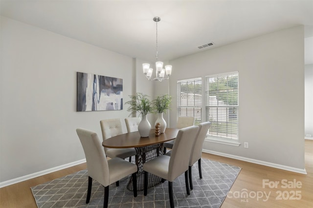 10225 Alexander Martin Ave, Charlotte, NC 28277 - dining room with a chandelier and wood finished floors