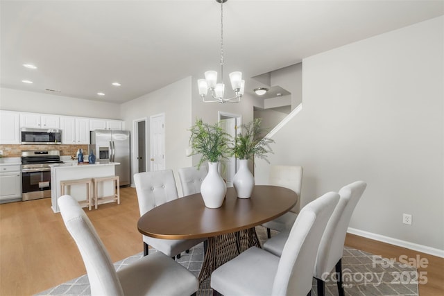 10225 Alexander Martin Ave, Charlotte, NC 28277 - dining area with a chandelier, light wood-style floors, and recessed lighting