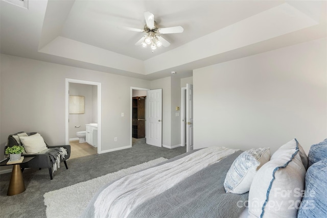 10225 Alexander Martin Ave, Charlotte, NC 28277 - bedroom with light colored carpet, a tray ceiling, ensuite bathroom, a spacious closet, and ceiling fan