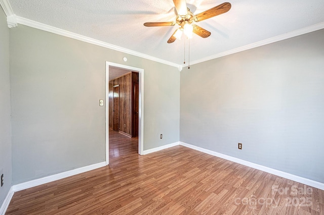 2031 36th St NE, Hickory, NC 28601 - empty room featuring ceiling fan, wood finished floors, baseboards, and ornamental molding