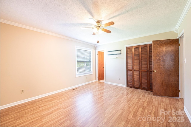 2031 36th St NE, Hickory, NC 28601 - unfurnished bedroom featuring crown molding, a textured ceiling, light wood finished floors, a closet, and baseboards