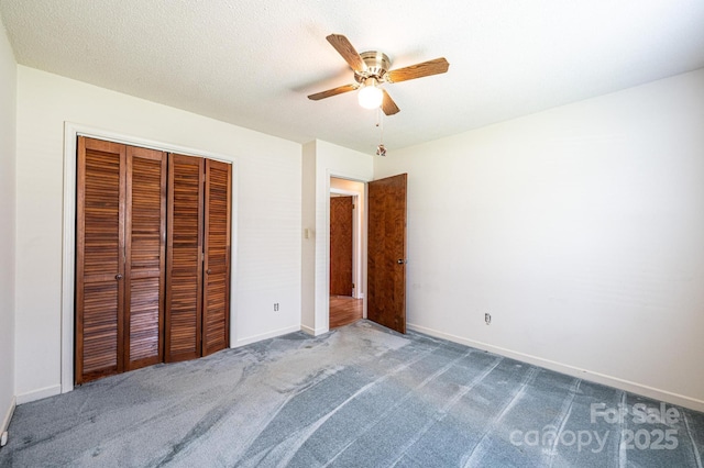 2031 36th St NE, Hickory, NC 28601 - unfurnished bedroom with carpet flooring, a closet, baseboards, and a ceiling fan