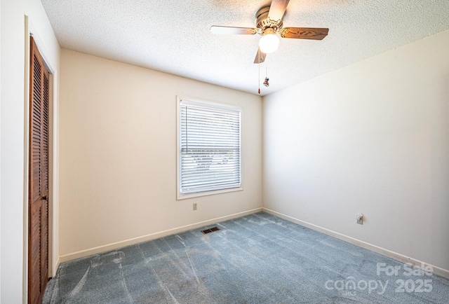 2031 36th St NE, Hickory, NC 28601 - unfurnished bedroom featuring a closet, carpet flooring, a textured ceiling, baseboards, and a ceiling fan