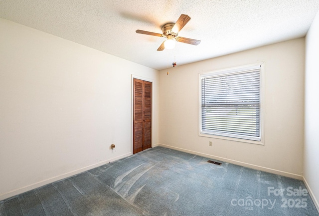 2031 36th St NE, Hickory, NC 28601 - spare room with a ceiling fan, carpet, baseboards, and a textured ceiling