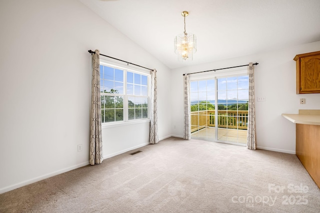 87 Collins Rd, Marshall, NC 28753 - unfurnished dining area featuring a chandelier, healthy amount of natural light, light carpet, lofted ceiling, and baseboards