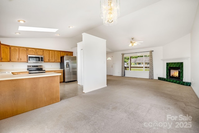 87 Collins Rd, Marshall, NC 28753 - kitchen with appliances with stainless steel finishes, lofted ceiling, open floor plan, light colored carpet, and brown cabinetry