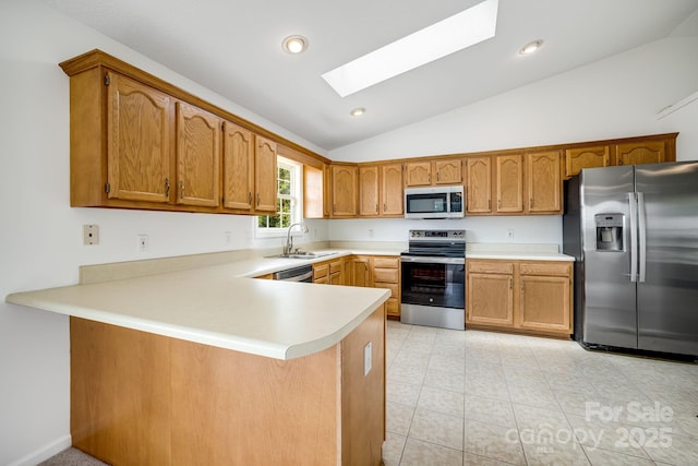 87 Collins Rd, Marshall, NC 28753 - kitchen with appliances with stainless steel finishes, a sink, a skylight, lofted ceiling, and a peninsula