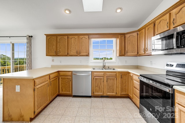 87 Collins Rd, Marshall, NC 28753 - kitchen with appliances with stainless steel finishes, a sink, a peninsula, light countertops, and a skylight