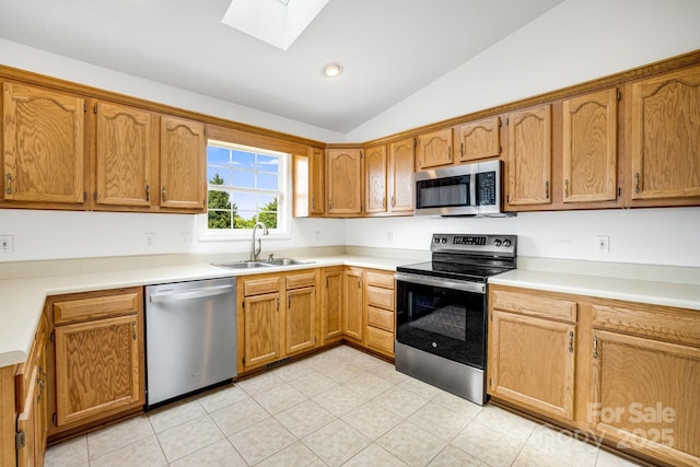 87 Collins Rd, Marshall, NC 28753 - kitchen featuring appliances with stainless steel finishes, vaulted ceiling, a sink, a skylight, and light countertops
