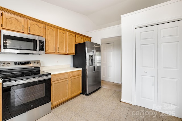 87 Collins Rd, Marshall, NC 28753 - kitchen with stainless steel appliances, light countertops, vaulted ceiling, and light tile patterned flooring