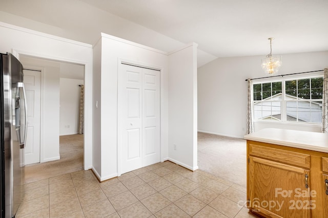 87 Collins Rd, Marshall, NC 28753 - unfurnished dining area featuring light colored carpet, a chandelier, vaulted ceiling, light tile patterned floors, and baseboards