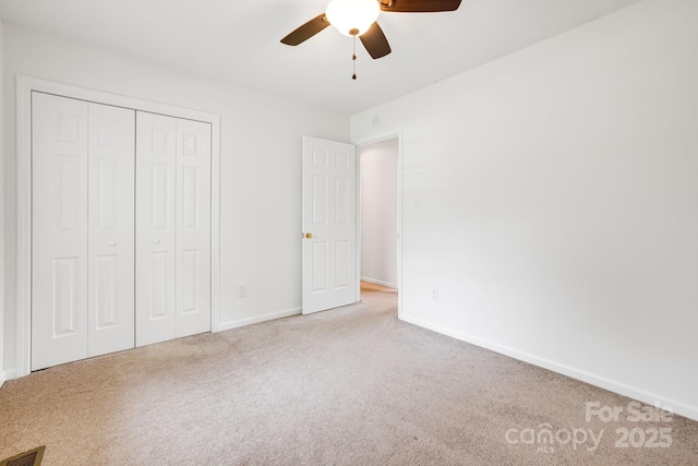 87 Collins Rd, Marshall, NC 28753 - unfurnished bedroom with carpet, a closet, baseboards, and a ceiling fan