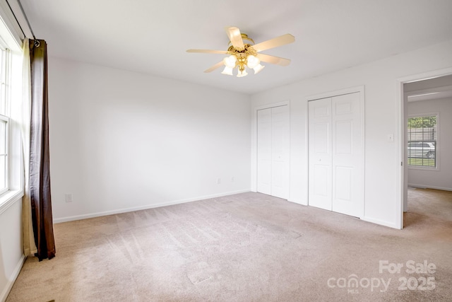 87 Collins Rd, Marshall, NC 28753 - unfurnished bedroom with two closets, carpet flooring, baseboards, and ceiling fan