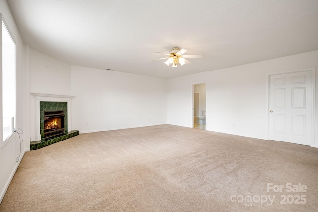 87 Collins Rd, Marshall, NC 28753 - unfurnished living room featuring carpet floors, ceiling fan, a tile fireplace, and baseboards