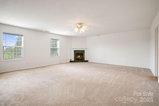 87 Collins Rd, Marshall, NC 28753 - unfurnished living room featuring ceiling fan, light carpet, baseboards, and a high end fireplace
