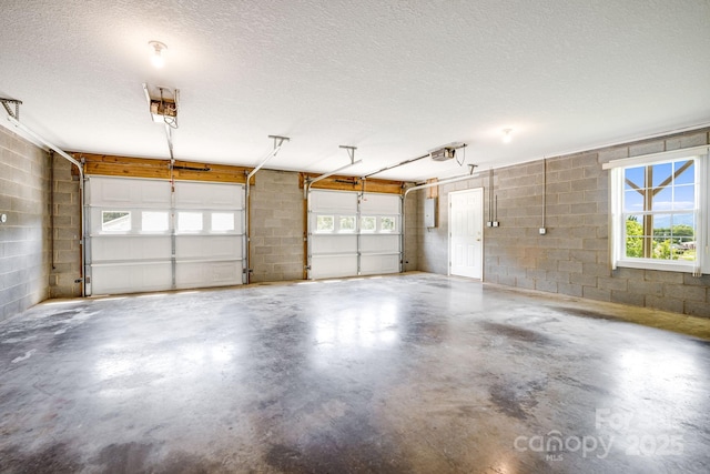 87 Collins Rd, Marshall, NC 28753 - garage featuring concrete block wall and a garage door opener