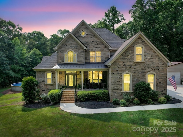 8101 Cane Pointe Ln, Waxhaw, NC 28173 - view of front of property featuring brick siding, a yard, and covered porch