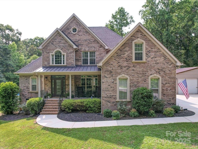 8101 Cane Pointe Ln, Waxhaw, NC 28173 - view of front of property featuring a front yard, covered porch, brick siding, and an outdoor structure