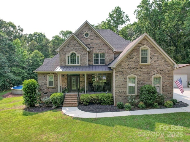 8101 Cane Pointe Ln, Waxhaw, NC 28173 - view of front facade with brick siding, a front yard, and a porch