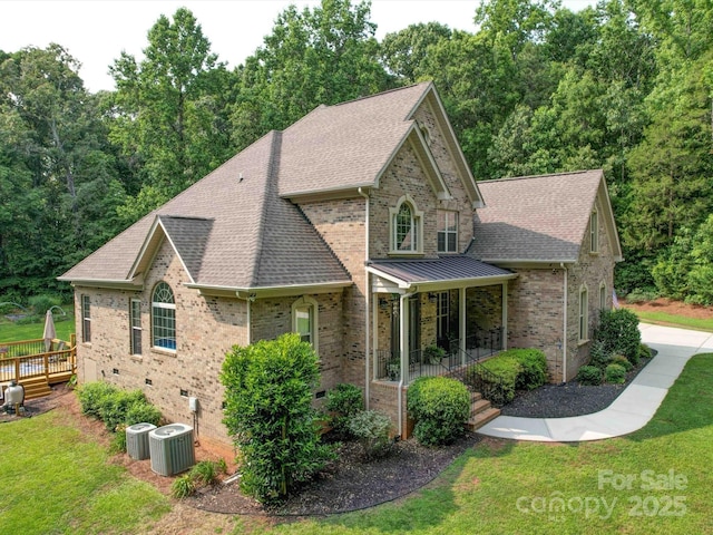 8101 Cane Pointe Ln, Waxhaw, NC 28173 - view of front of house with a shingled roof, brick siding, a front yard, central air condition unit, and crawl space