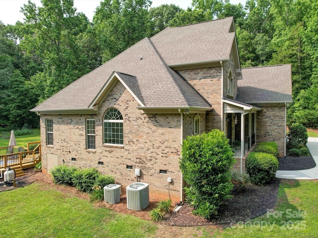 8101 Cane Pointe Ln, Waxhaw, NC 28173 - view of side of property with a shingled roof, central AC unit, brick siding, a deck, and a lawn