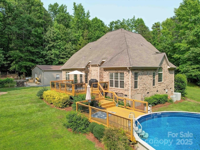 8101 Cane Pointe Ln, Waxhaw, NC 28173 - back of house featuring a deck, a lawn, brick siding, an outdoor pool, and a shingled roof