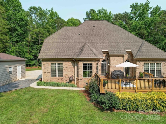 8101 Cane Pointe Ln, Waxhaw, NC 28173 - back of house featuring brick siding, roof with shingles, a deck, and a lawn