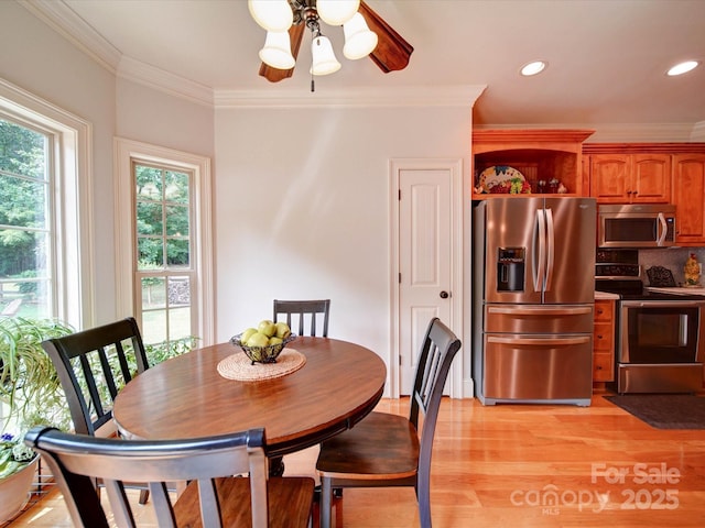 8101 Cane Pointe Ln, Waxhaw, NC 28173 - dining space featuring crown molding, light wood-type flooring, and recessed lighting