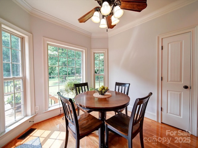 8101 Cane Pointe Ln, Waxhaw, NC 28173 - dining room with ornamental molding, light wood finished floors, a ceiling fan, and baseboards