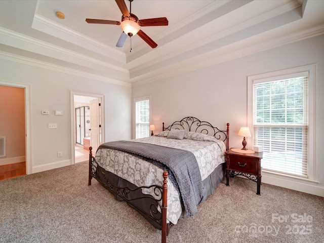 8101 Cane Pointe Ln, Waxhaw, NC 28173 - bedroom with a raised ceiling, multiple windows, carpet flooring, crown molding, and ensuite bathroom