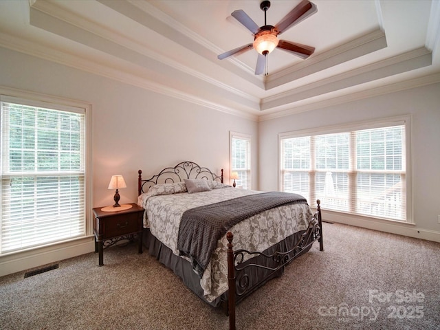 8101 Cane Pointe Ln, Waxhaw, NC 28173 - carpeted bedroom featuring a raised ceiling, ornamental molding, multiple windows, and a ceiling fan