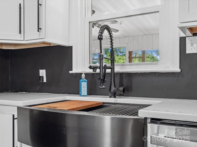 1238 Carl Allen Rd, Edgemoor, SC 29712 - kitchen view of white cabinetry, light countertops, tasteful backsplash, and stainless steel dishwasher