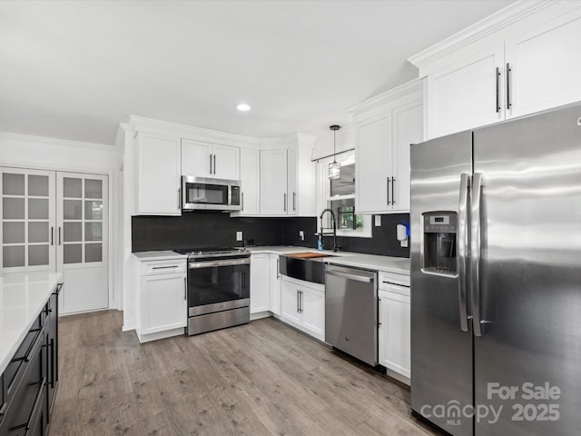 1238 Carl Allen Rd, Edgemoor, SC 29712 - kitchen with appliances with stainless steel finishes, white cabinetry, decorative backsplash, recessed lighting, and wood finished floors