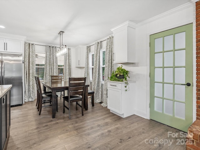 1238 Carl Allen Rd, Edgemoor, SC 29712 - dining area featuring light wood-type flooring, a chandelier, and ornamental molding