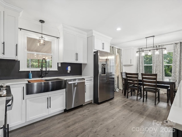 1238 Carl Allen Rd, Edgemoor, SC 29712 - kitchen featuring stainless steel appliances, white cabinetry, wood finished floors, decorative light fixtures, and recessed lighting