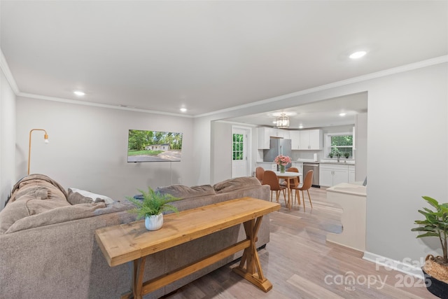 4410 Burgin St, Kannapolis, NC 28081 - living room featuring recessed lighting, light wood-style floors, ornamental molding, and a chandelier